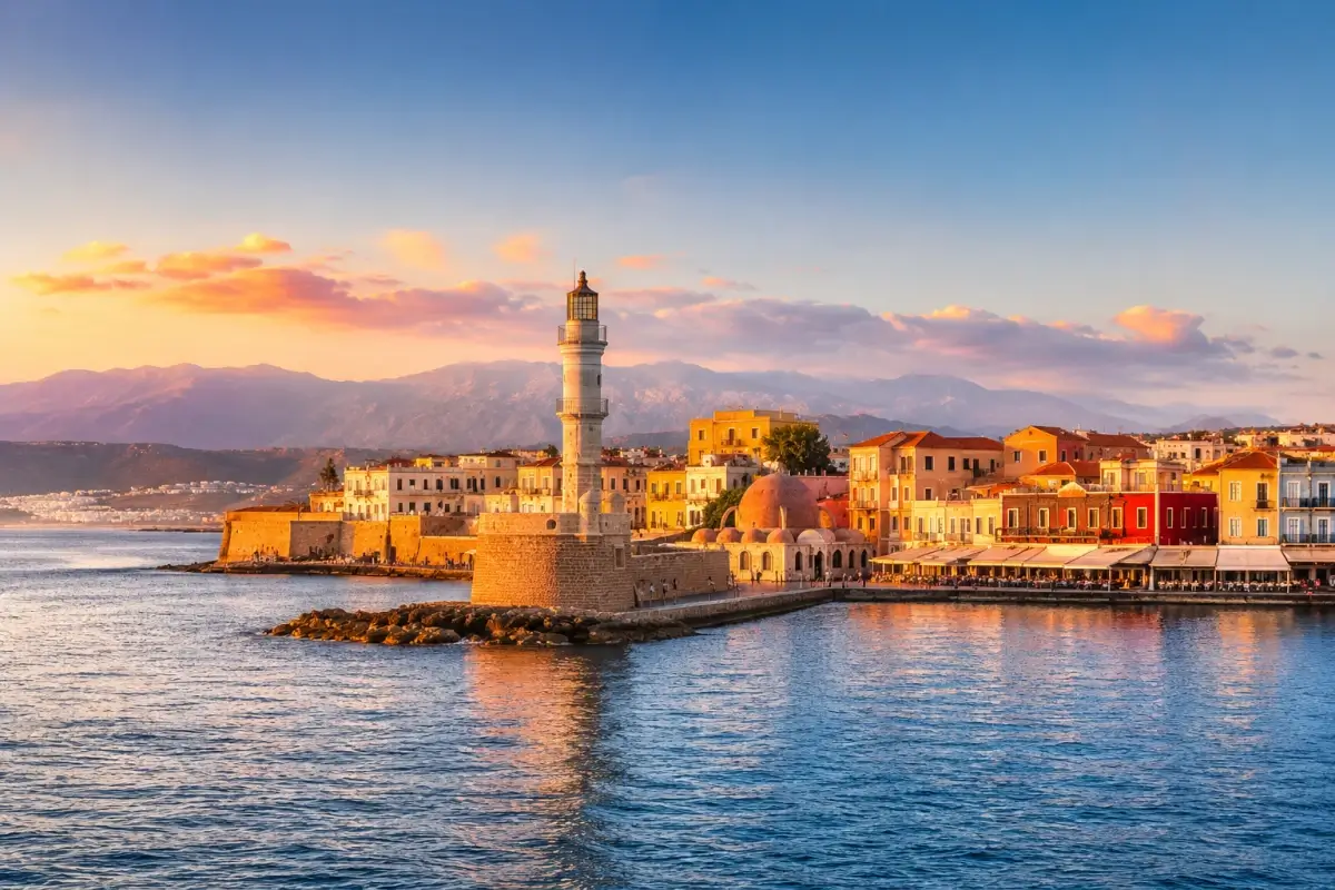 Chania's Venetian Harbor and lighthouse in Crete at sunset