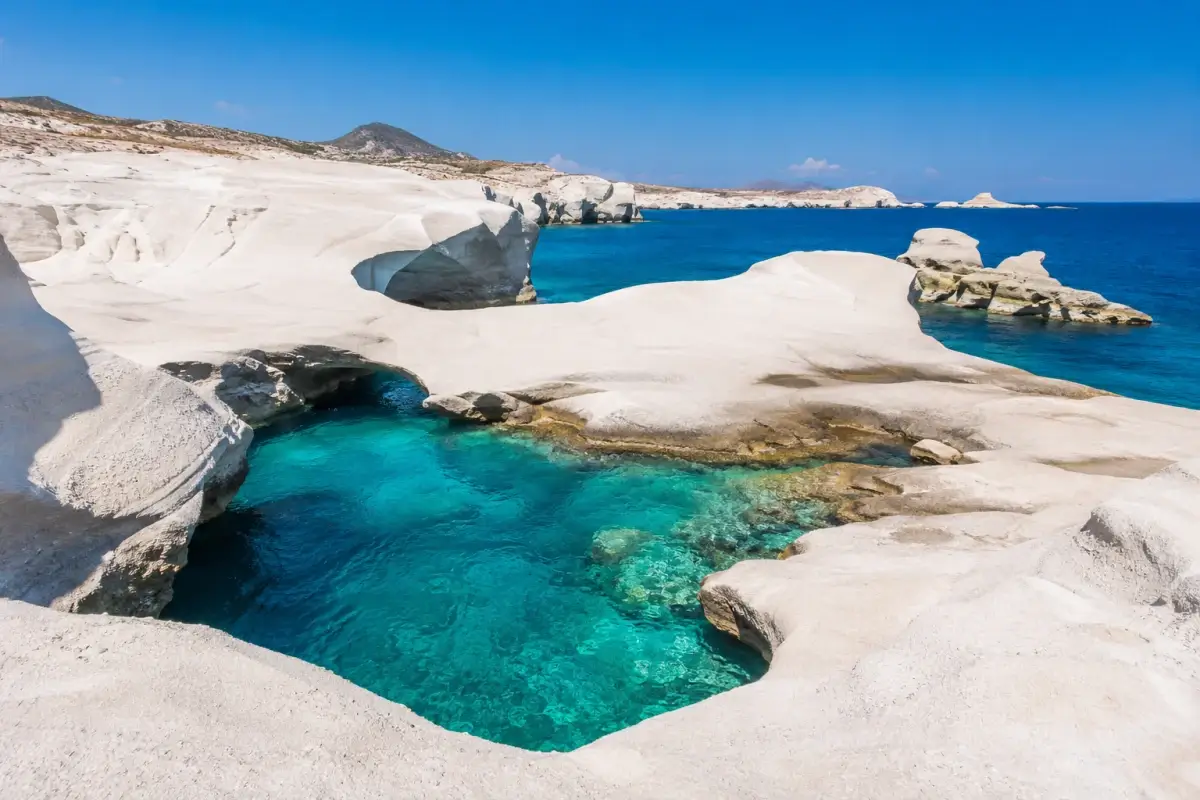 White volcanic rock formations and turquoise water at Sarakiniko Beach in Milos
