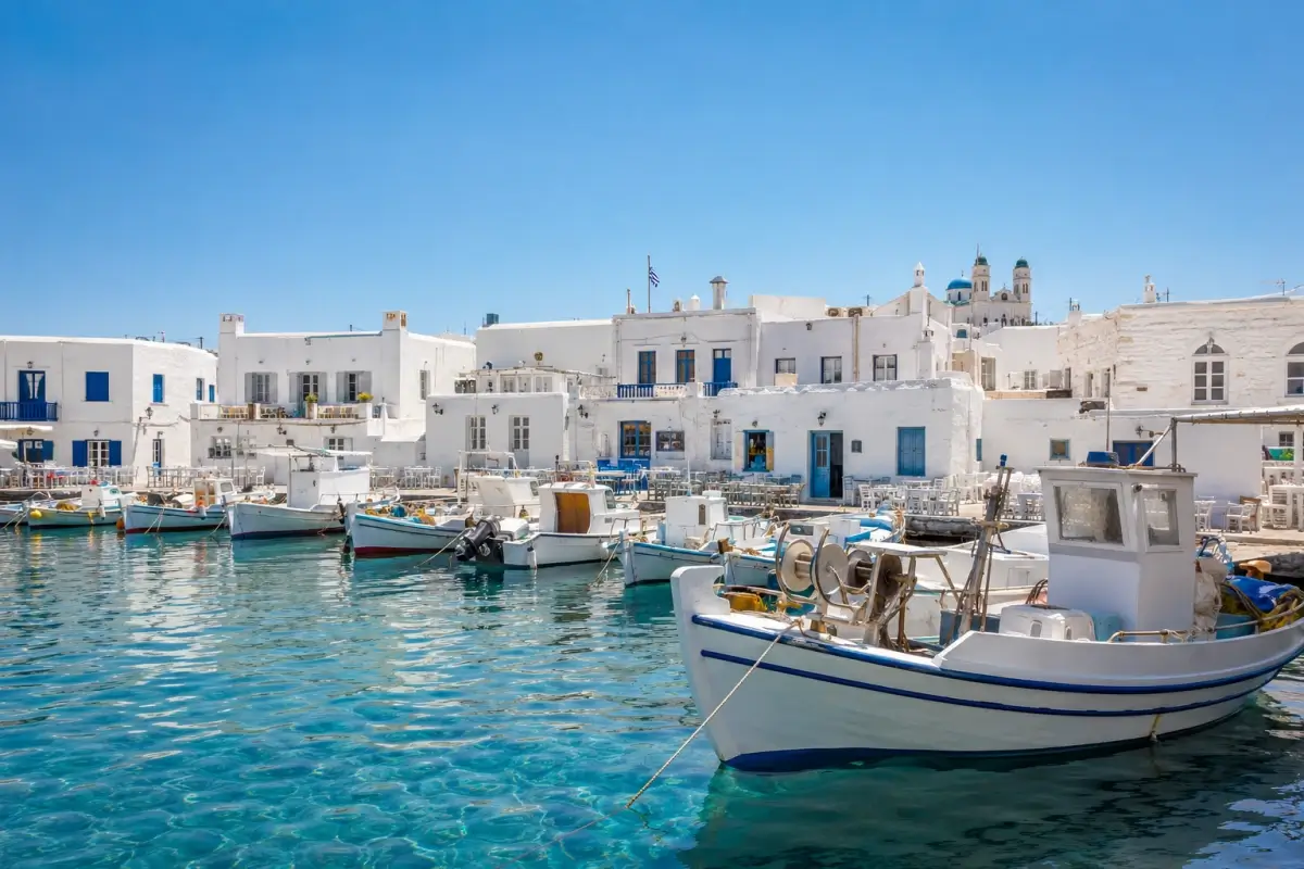 Fishing boats and whitewashed buildings around Naoussa harbor on Paros