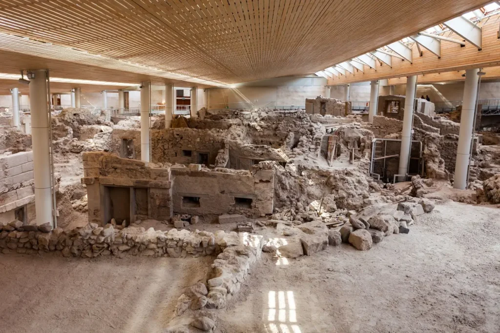 Excavated stone buildings beneath the protective roof at Akrotiri in Santorini.