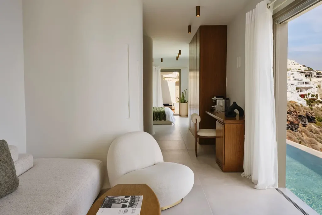 Suite interior opening onto a pool terrace at Andronis Luxury Suites in Oia.