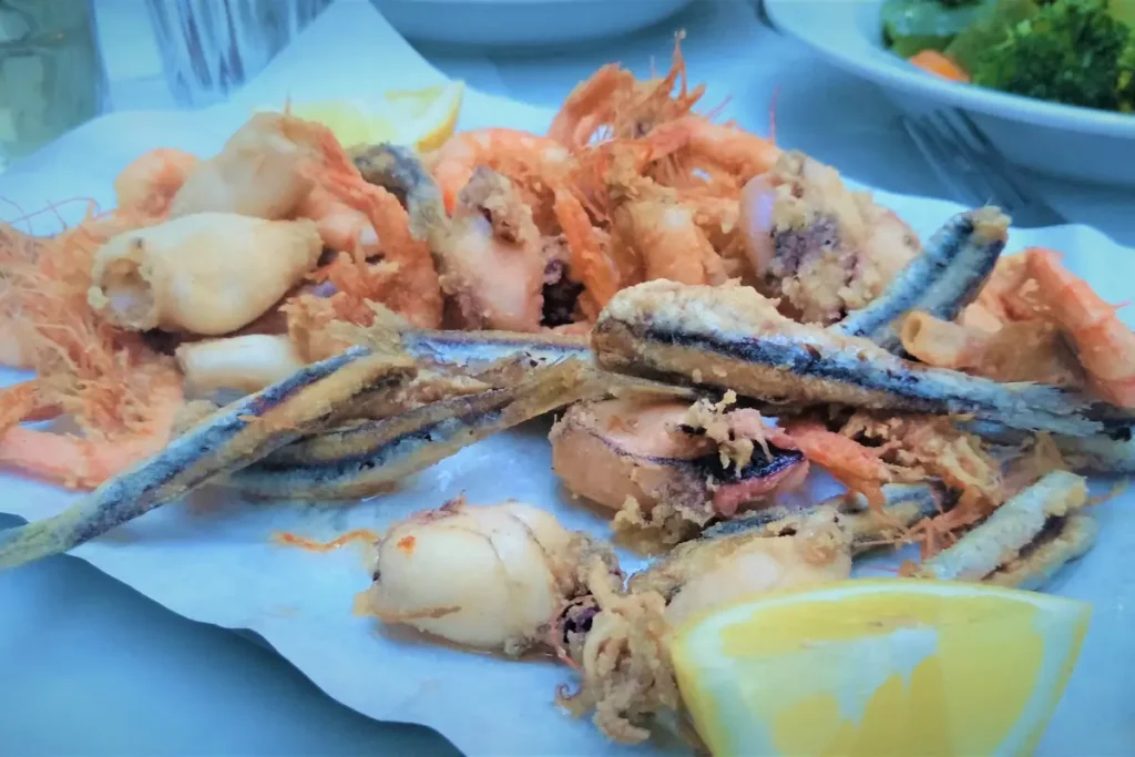 A platter of fried small fish, shrimp and squid with lemon wedges at Atlantikos in Athens.