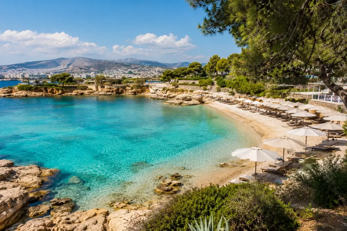 Clear turquoise water and a pine-lined beach along the Athens Riviera