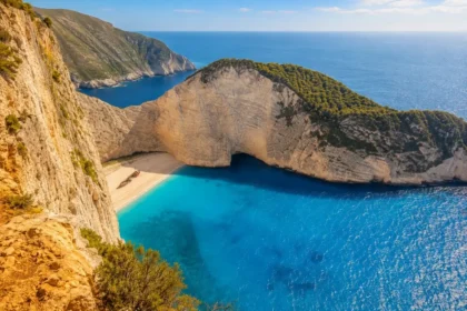 Navagio Beach in Zakynthos with turquoise water, white limestone cliffs, and the shipwreck below