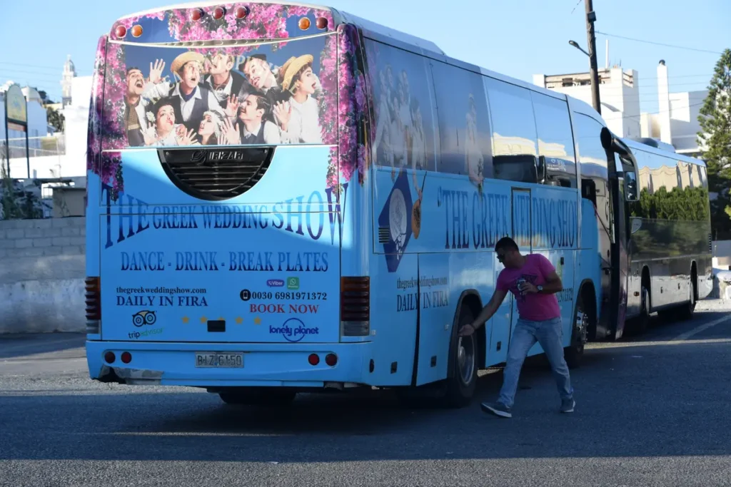 Blue coach parked at the main KTEL bus station in Fira, Santorini.
