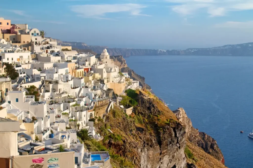 White buildings and terraces clustered along Fira’s volcanic cliff above the caldera.