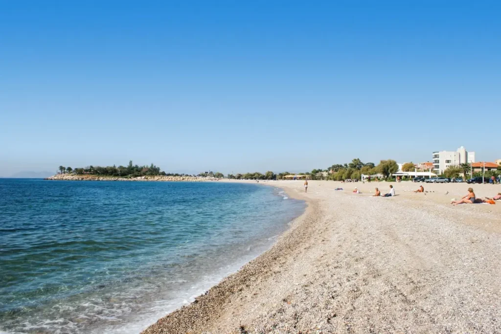 A stretch of Glyfada’s shoreline beside clear blue water.