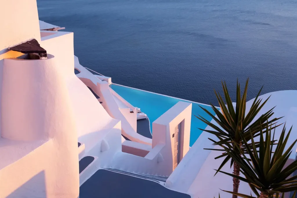Whitewashed terraces and a turquoise infinity pool above the sea at Katikies Santorini in Oia.