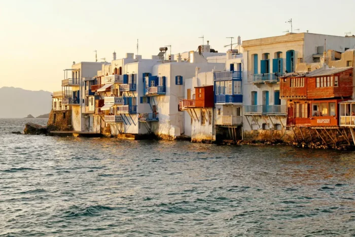 Colorful balconies on Little Venice's waterfront buildings above the sea in warm evening light