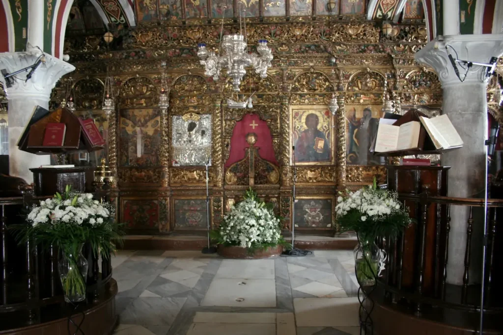 Gilded altar screen, religious icons and chandeliers inside Panagia Tourliani in Ano Mera