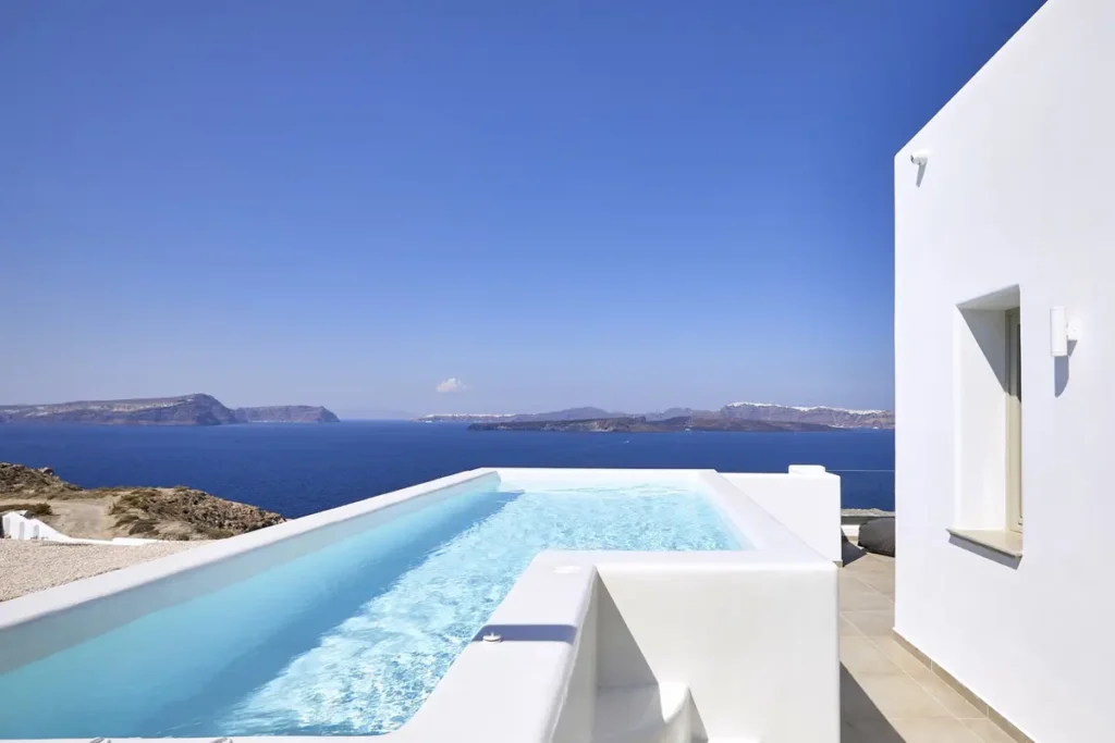 Private pool beside a white suite overlooking the caldera at Phos in Akrotiri.