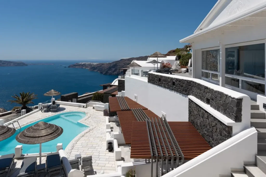 Swimming pool and sun terrace overlooking the caldera at Santorini Princess Spa Hotel.