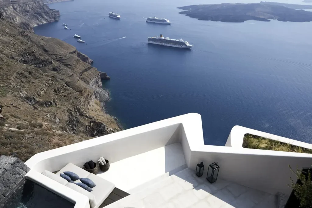 Minimalist terrace built into a steep volcanic cliff at Vora in Santorini.