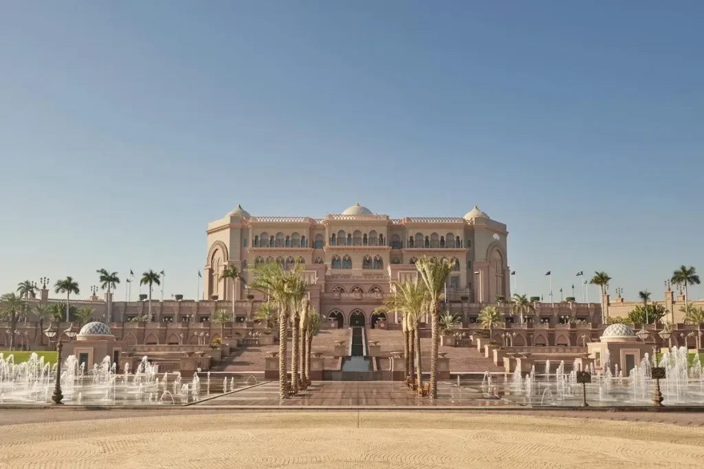 Central palace facade, palm-lined approach, and fountains at Emirates Palace Mandarin Oriental, Abu Dhabi.