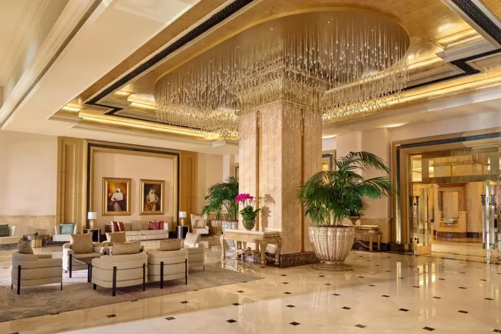 Marble floors, pale seating, and a large chandelier in the resort lobby at Emirates Palace Mandarin Oriental, Abu Dhabi.