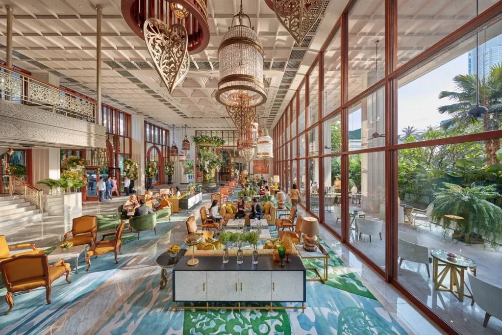Chandeliers, floral displays, and seating beside tall windows in the lobby at Mandarin Oriental, Bangkok.