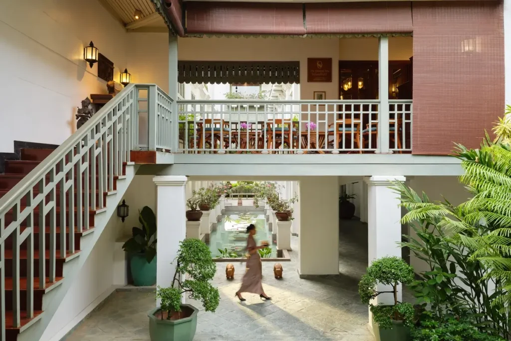 White balustrades, an open staircase, and tropical planting in the Oriental Spa courtyard at Mandarin Oriental, Bangkok.