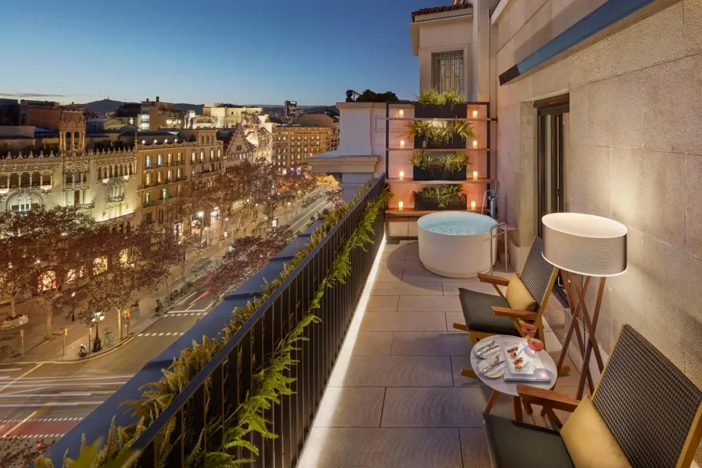 Outdoor seating and lamps on a Terrace Suite balcony overlooking Passeig de Gràcia at Mandarin Oriental, Barcelona.