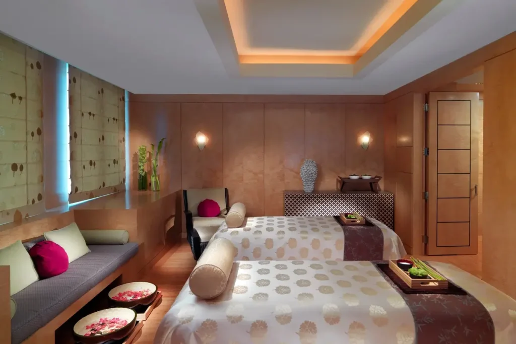 Two treatment beds and seating in the Mandarin couples spa suite at Mandarin Oriental, Boston.