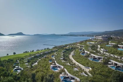 Aerial view of Mandarin Oriental, Costa Navarino, with landscaped hillside villas above Navarino Bay.