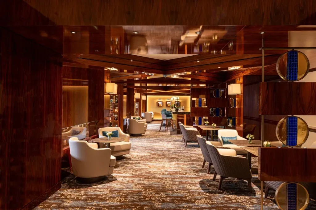 Upholstered chairs, small tables, and warm wood finishes in MO Bar at Mandarin Oriental, Geneva.