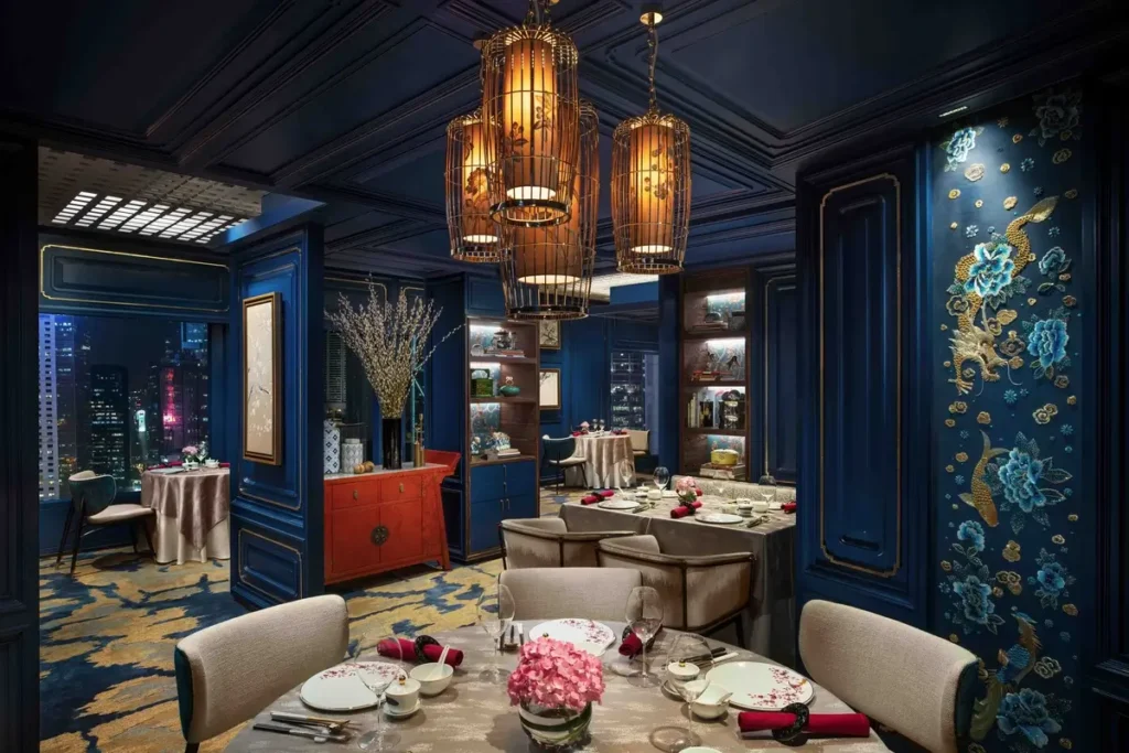 Dining tables and blue-paneled interiors at Man Wah in Mandarin Oriental, Hong Kong.