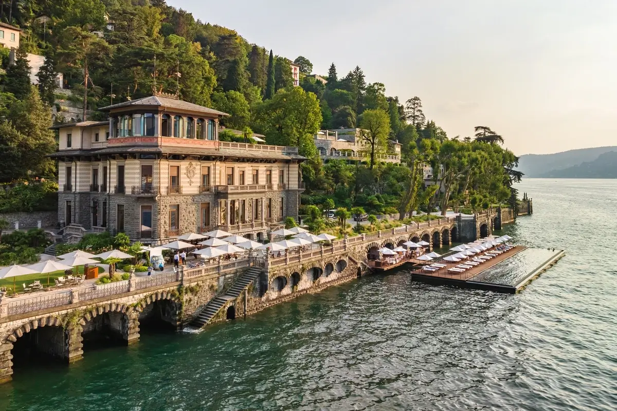 Historic waterfront buildings and landscaped terraces overlooking Lake Como at Mandarin Oriental, Lago di Como.
