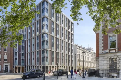 Contemporary facade of Mandarin Oriental Mayfair, London, framed by trees and neighboring buildings on Hanover Square.