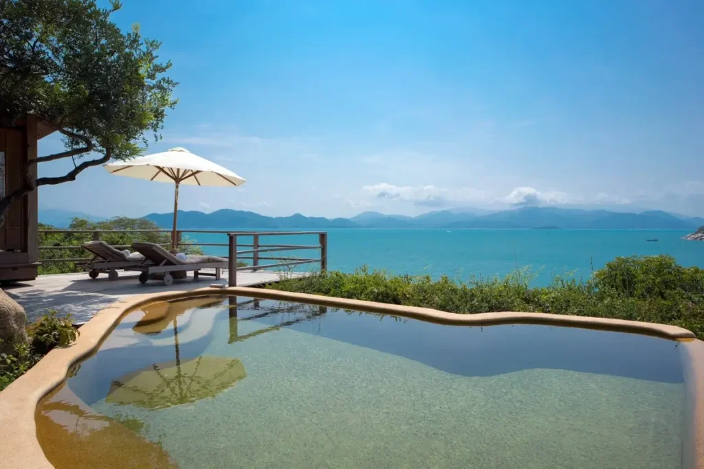 Curved private pool and sun loungers overlooking the sea at a Hilltop Pool Villa at Six Senses Ninh Van Bay