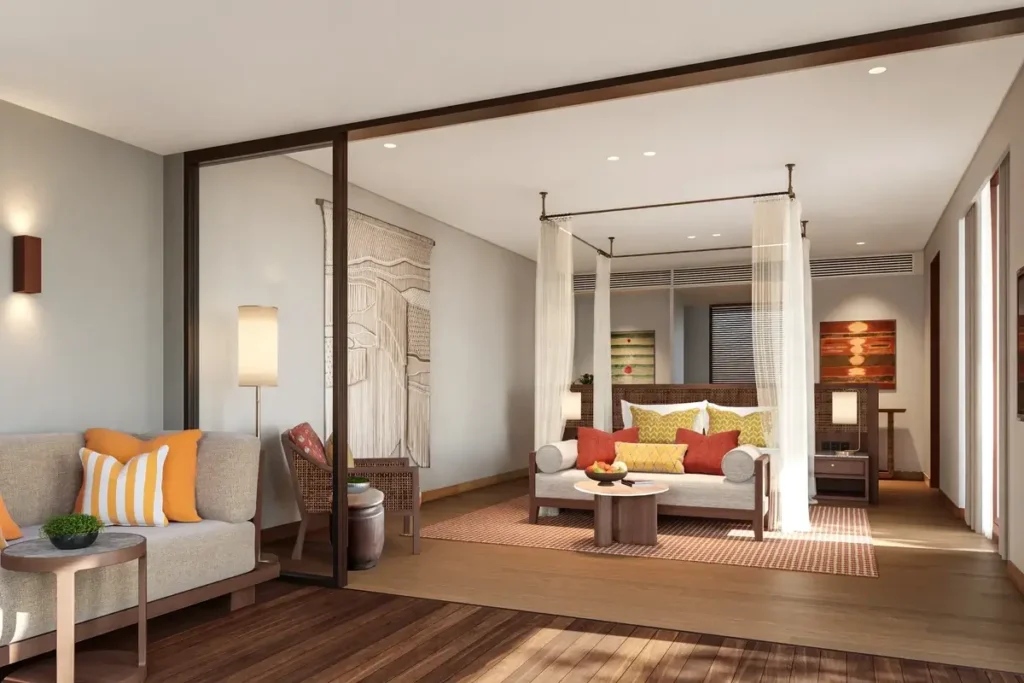 Sliding glass doors connect a terrace with cushioned seating to a pale bedroom with a canopy bed.